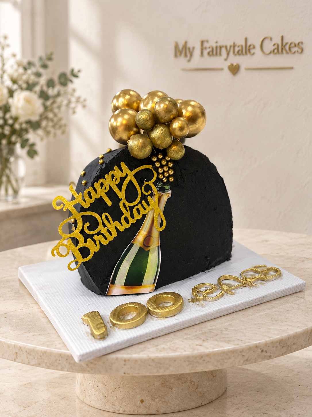 Andrea's black-and-gold champagne-popping birthday cake