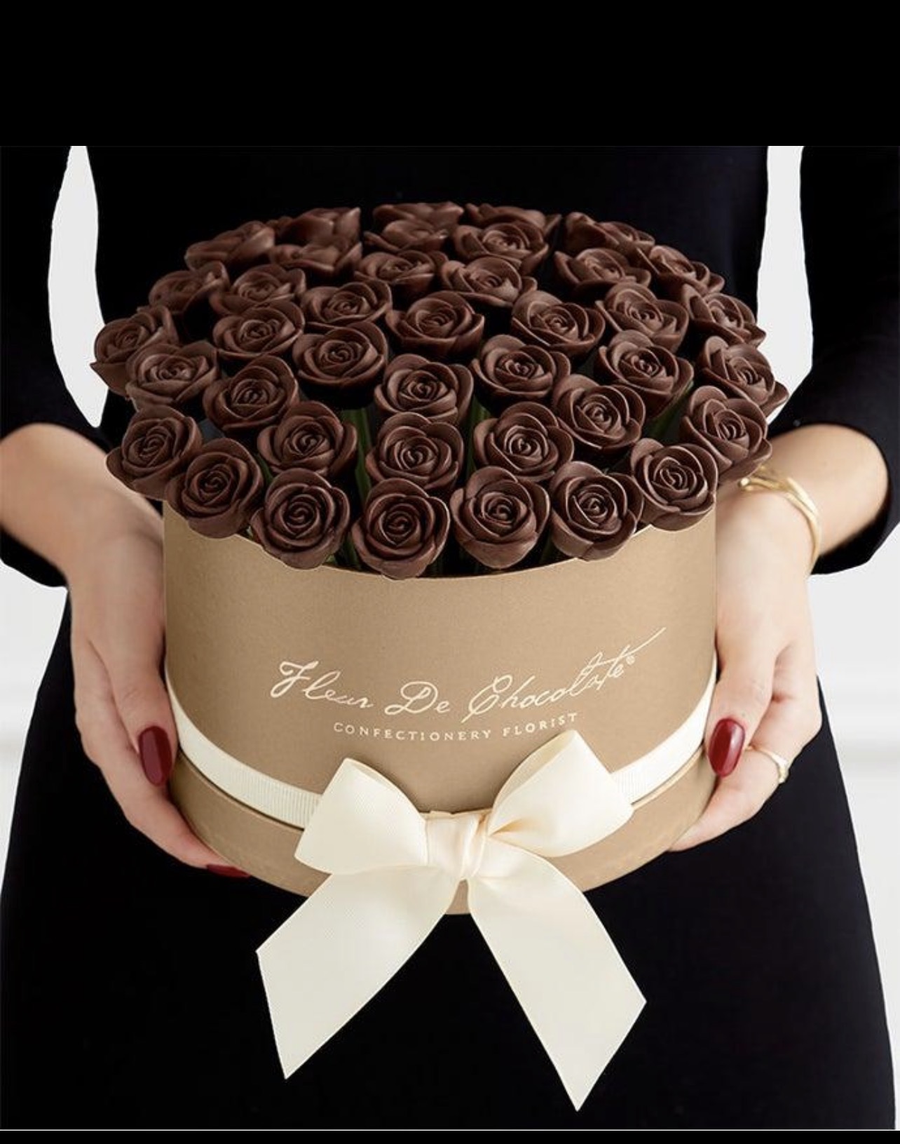 Chocolate rose cake bouquet held in a luxury round gift box